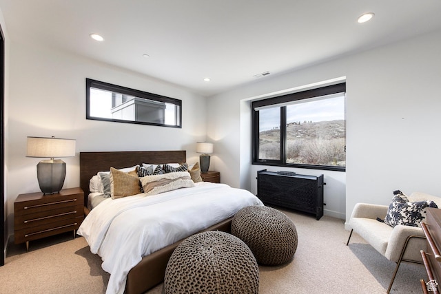 bedroom featuring light carpet, multiple windows, recessed lighting, and baseboards