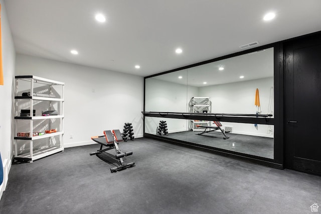 exercise room with recessed lighting and baseboards