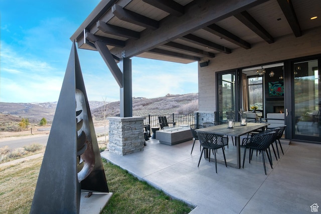 view of patio / terrace with a mountain view and outdoor dining space