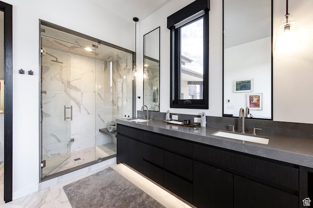 bathroom featuring marble finish flooring, a marble finish shower, and double vanity