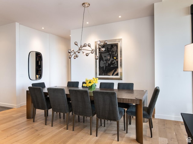 dining area with light wood finished floors, baseboards, a chandelier, and recessed lighting