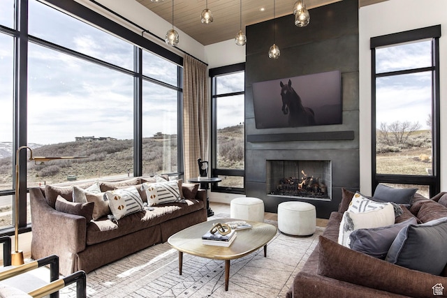 living area featuring a fireplace and wood ceiling