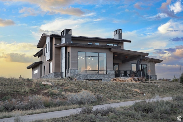 view of side of property with stone siding