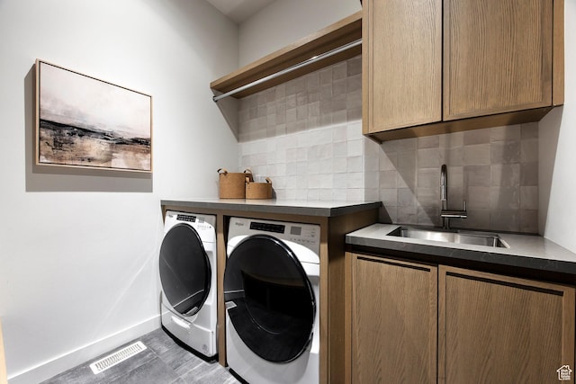 laundry area with washer and dryer, cabinet space, and baseboards