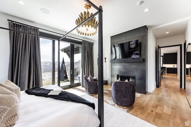 bedroom featuring access to outside, light wood-style floors, recessed lighting, and baseboards