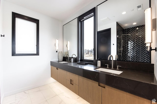 full bath featuring marble finish flooring, a stall shower, double vanity, recessed lighting, and baseboards