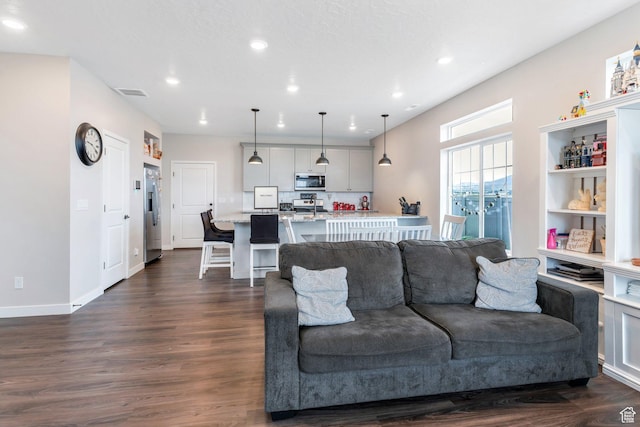 24 S Baker Spring Cv, Saratoga Springs, UT 84045 - living room with recessed lighting and dark wood finished floors