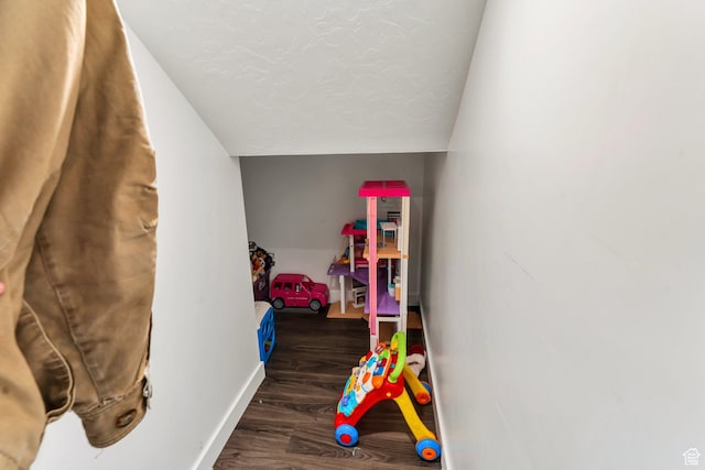24 S Baker Spring Cv, Saratoga Springs, UT 84045 - playroom with wood finished floors, baseboards, lofted ceiling, and a textured ceiling