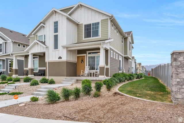 24 S Baker Spring Cv, Saratoga Springs, UT 84045 - view of front of house with a porch, board and batten siding, fence, and a residential view