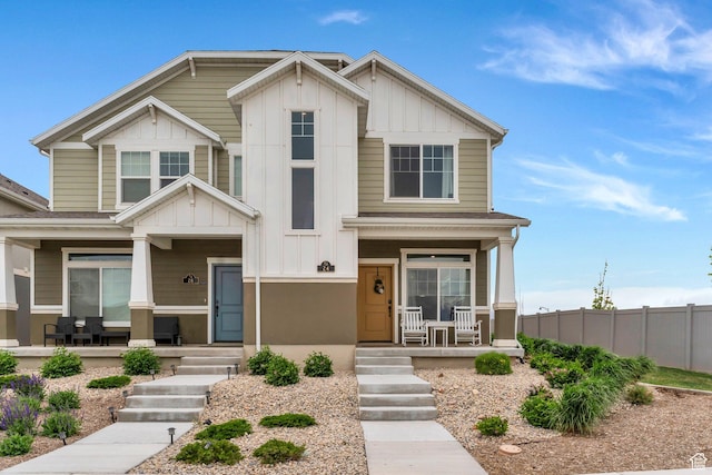 24 S Baker Spring Cv, Saratoga Springs, UT 84045 - view of front of house featuring covered porch, board and batten siding, and fence