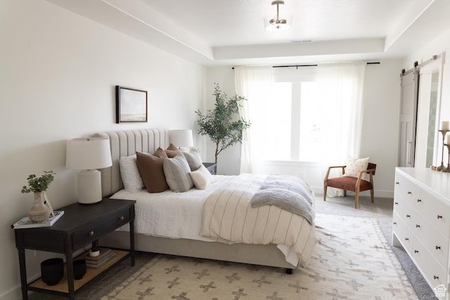 6489 W Yawkey Way, Herriman, UT 84096 - bedroom with a barn door, a raised ceiling, and light carpet
