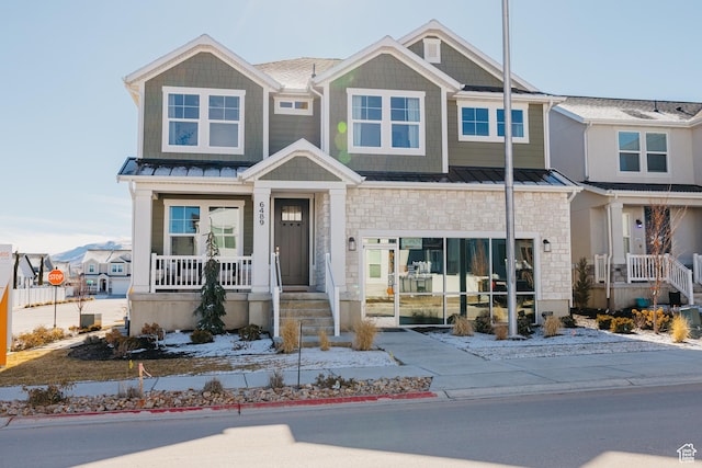 6489 W Yawkey Way, Herriman, UT 84096 - view of front of property featuring stone siding, a standing seam roof, a porch, and metal roof
