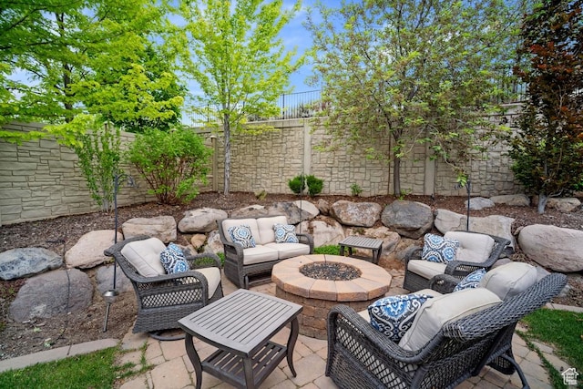 view of patio featuring a fenced backyard and an outdoor living space with a fire pit