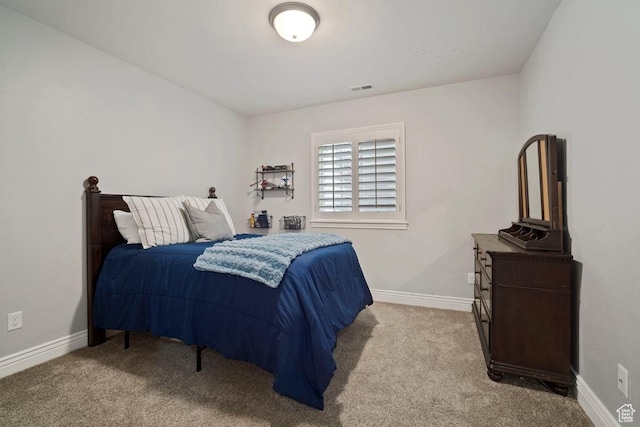 bedroom with carpet flooring and baseboards