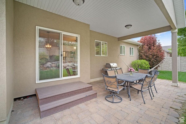 view of patio featuring outdoor dining space and fence