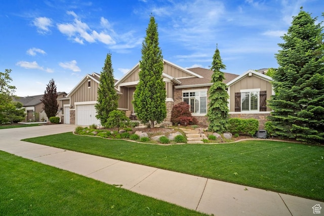 craftsman inspired home featuring board and batten siding, concrete driveway, stone siding, a front lawn, and an attached garage