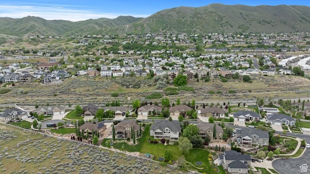 aerial view of property's location featuring nearby suburban area and mountains