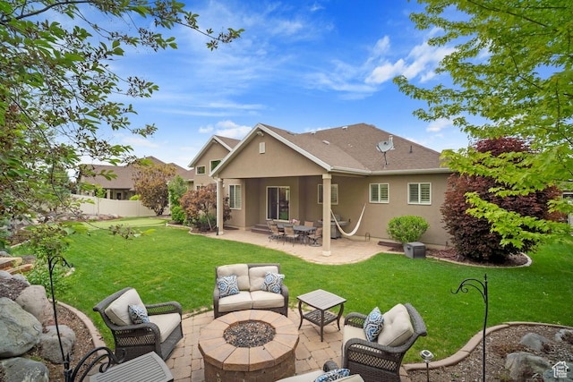 back of house with an outdoor living space with a fire pit, a patio, and stucco siding