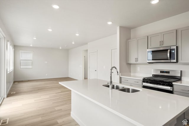 3457 S 3100 W Unit 174, West Haven, UT 84401 - kitchen with appliances with stainless steel finishes, gray cabinetry, light countertops, light wood-style flooring, and recessed lighting