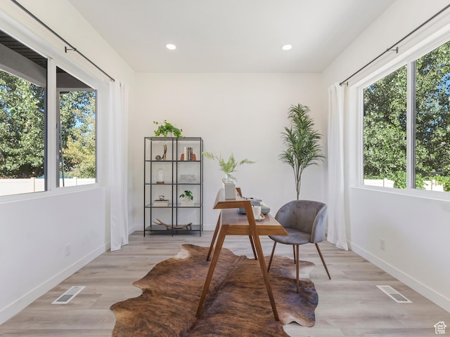 office space featuring plenty of natural light, baseboards, recessed lighting, and light wood-type flooring