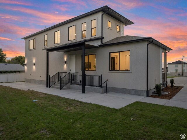 back of house with a patio area and stucco siding