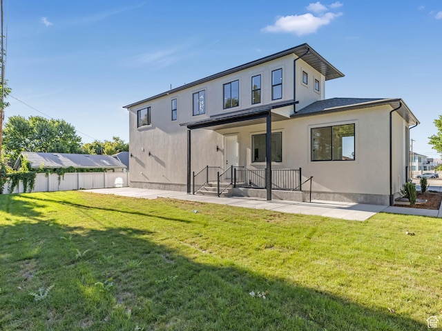 rear view of property with a patio area and stucco siding