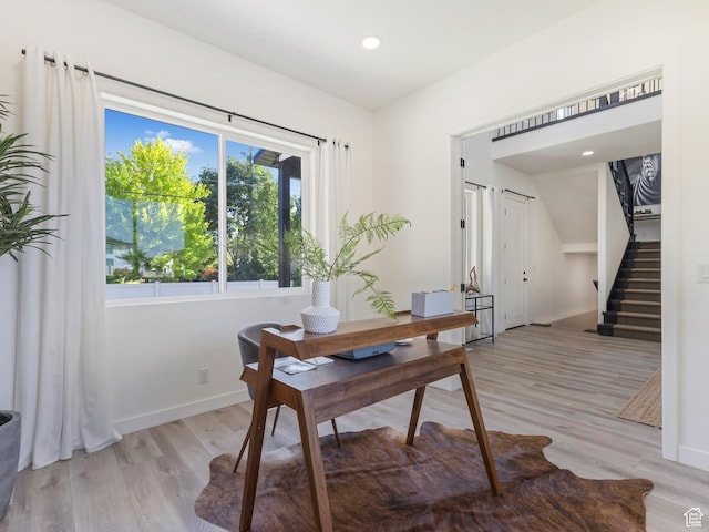 office space featuring light wood-style flooring, baseboards, and recessed lighting
