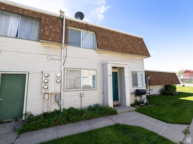4318 S 1100 W Unit 34C, Salt Lake City, UT 84123 - view of property with roof with shingles, mansard roof, and a front yard