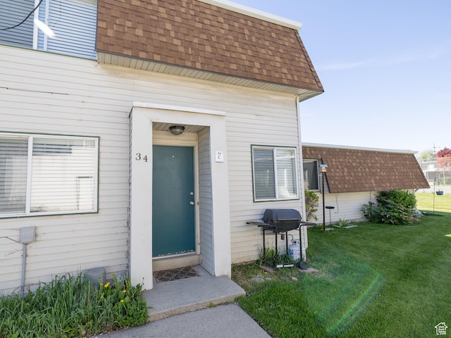 4318 S 1100 W Unit 34C, Salt Lake City, UT 84123 - entrance to property featuring a shingled roof, mansard roof, and a yard