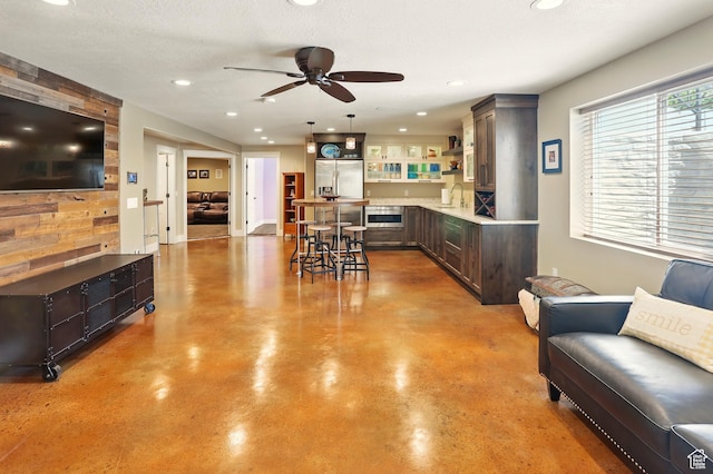 7639 S 475 W, Willard, UT 84340 - living area with finished concrete flooring, a ceiling fan, and recessed lighting