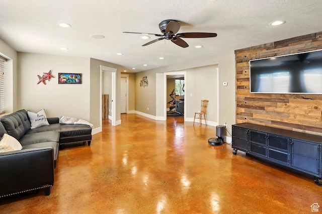 7639 S 475 W, Willard, UT 84340 - living area featuring concrete flooring, a ceiling fan, recessed lighting, baseboards, and wood walls