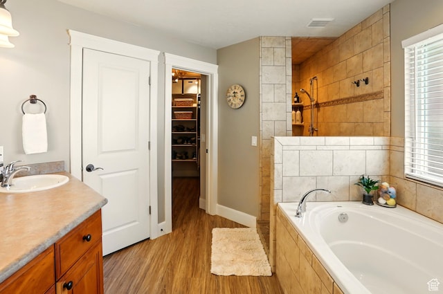 7639 S 475 W, Willard, UT 84340 - full bath featuring wood finished floors, a tile shower, a garden tub, a walk in closet, and vanity