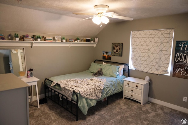 bedroom featuring dark carpet, lofted ceiling, and a ceiling fan
