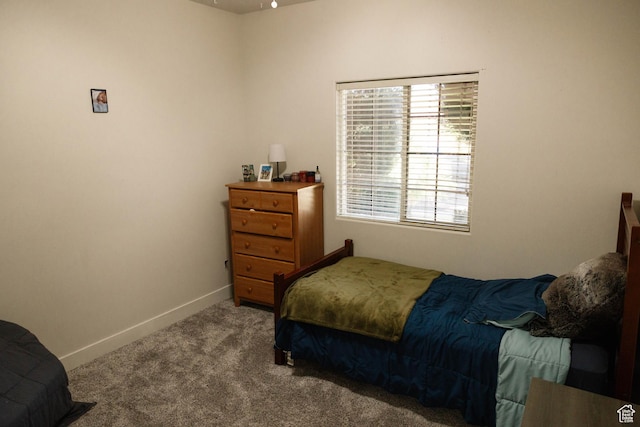 bedroom featuring carpet floors and baseboards