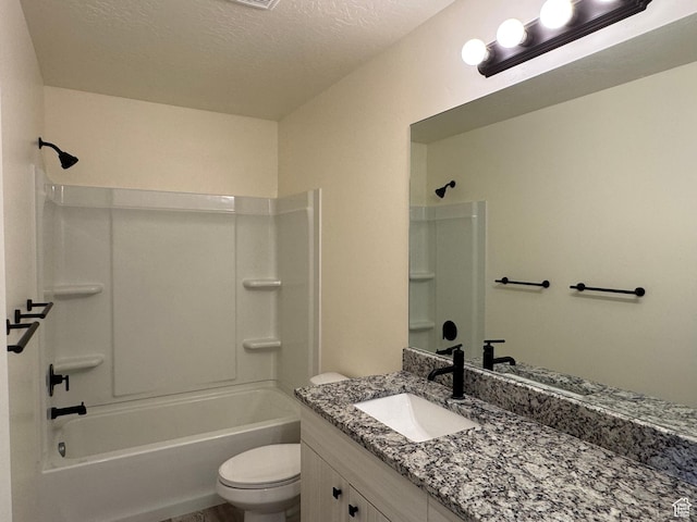 full bathroom featuring toilet, vanity, tub / shower combination, and a textured ceiling