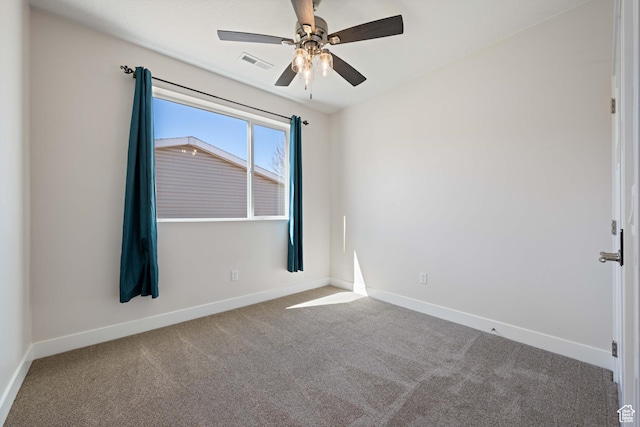spare room featuring carpet, baseboards, and ceiling fan