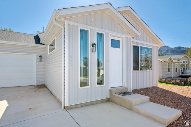 view of side of property featuring a garage, driveway, and a mountain view