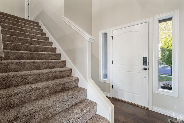 6966 N S Pass Rd, Eagle Mountain, UT 84005 - entrance foyer featuring stairs, dark wood-style floors, and baseboards