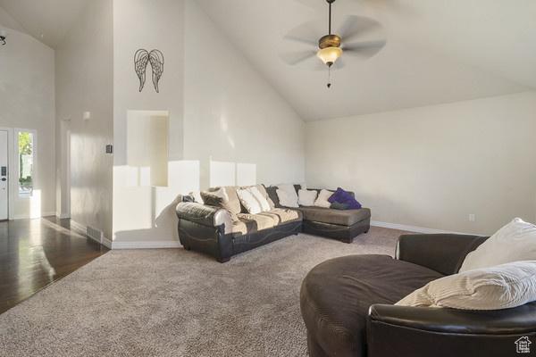 6966 N S Pass Rd, Eagle Mountain, UT 84005 - living room featuring high vaulted ceiling, carpet, baseboards, and a ceiling fan