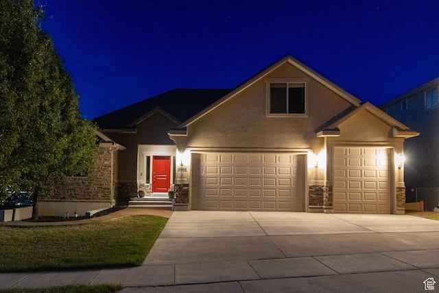 6966 N S Pass Rd, Eagle Mountain, UT 84005 - view of front of property featuring stone siding, concrete driveway, a garage, and stucco siding