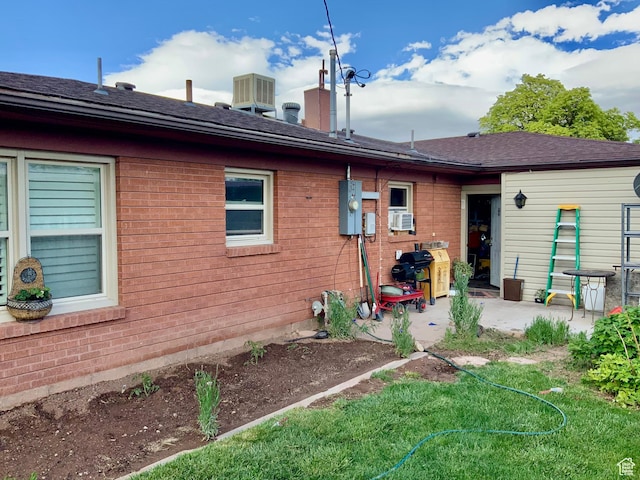 111 W 570 N, Richfield, UT 84701 - back of house with a patio, central air condition unit, cooling unit, and brick siding