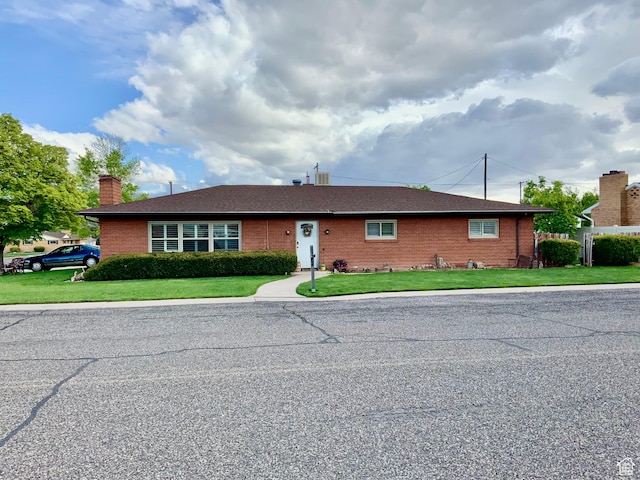 111 W 570 N, Richfield, UT 84701 - ranch-style house featuring a chimney, brick siding, and a front lawn