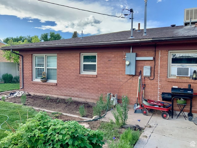 111 W 570 N, Richfield, UT 84701 - view of side of home with brick siding, roof with shingles, and central air condition unit
