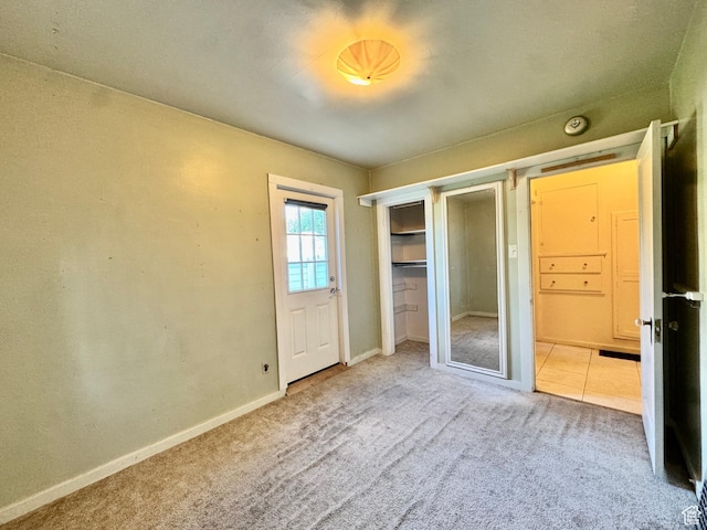 unfurnished bedroom with carpet floors and baseboards