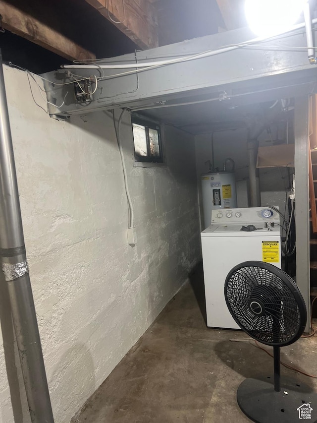 unfinished below grade area featuring washer / dryer and electric water heater