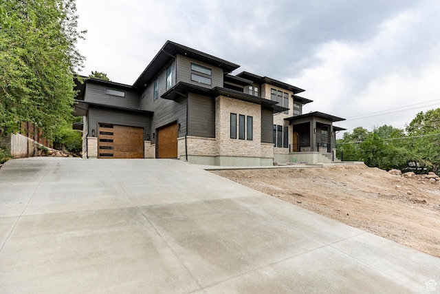 3756 E Hermes Dr, Salt Lake City, UT 84124 - view of front of property with stone siding, concrete driveway, and an attached garage