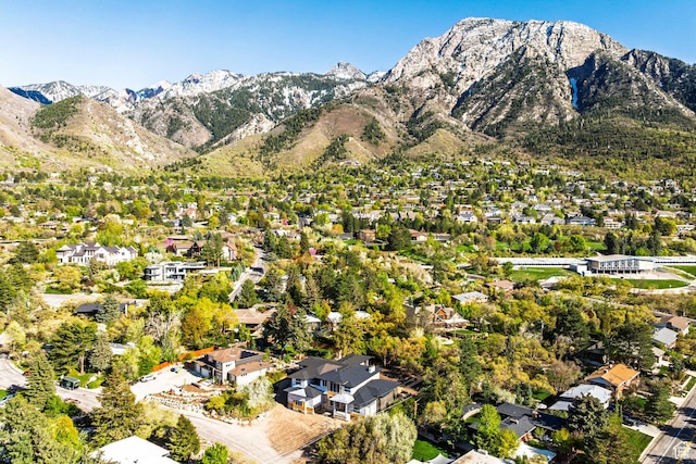 view of property location featuring a mountain backdrop and nearby suburban area