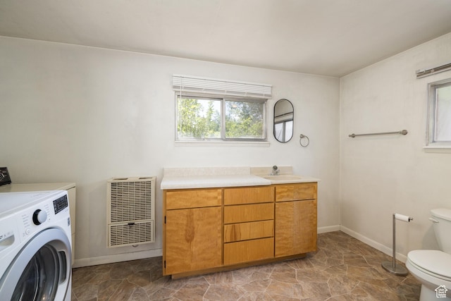 142 Hillside Dr, Moab, UT 84532 - bathroom with washer / dryer, heating unit, toilet, baseboards, and stone finish flooring