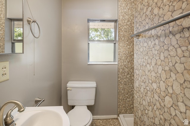 142 Hillside Dr, Moab, UT 84532 - full bath with a sink, walk in shower, toilet, and baseboards