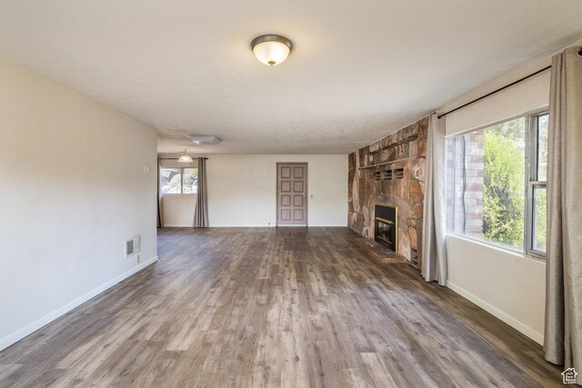142 Hillside Dr, Moab, UT 84532 - unfurnished living room with a fireplace, wood finished floors, and baseboards